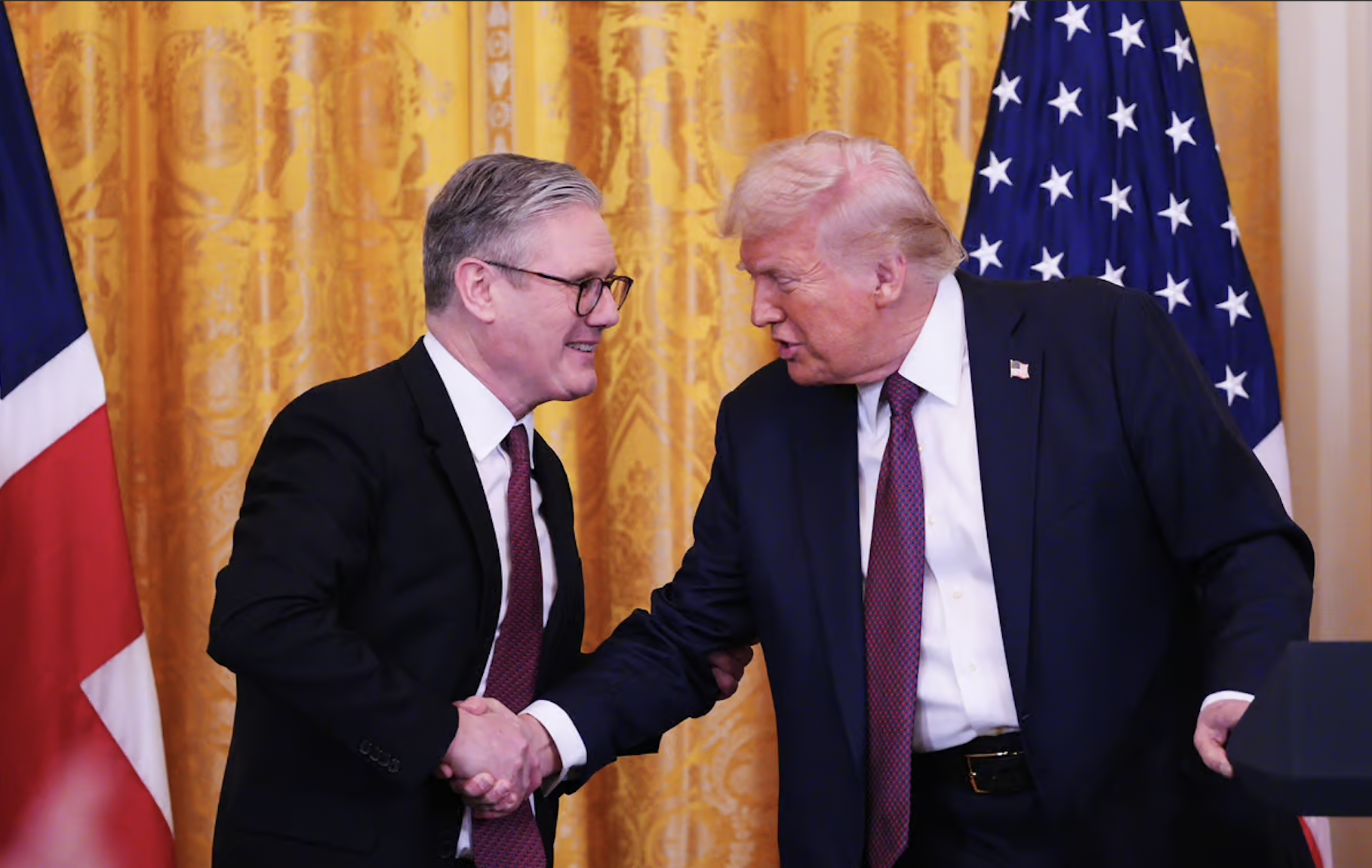President Donald Trump and Prime Minister Keir Starmer shaking hands at the White House during trade deal announcement